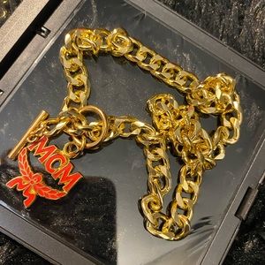 Authentic Mcm charm pull on a 18 karat gold plated, sterling, silver chain